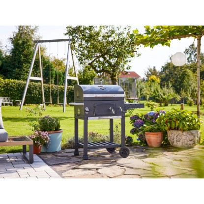 Jamestown Jaxon faszenes grill kocsi oldalsó asztallal és tárolóval a kertben. Jamestown Jaxon faszenes grill kocsi oldalsó asztallal és tárolóval a kertben.