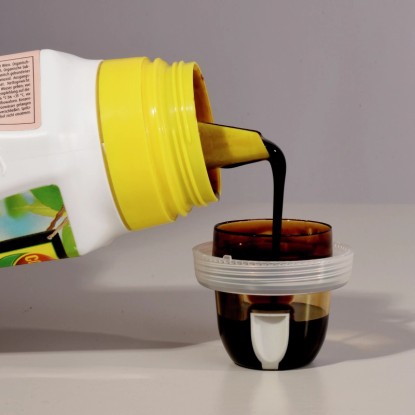 Compo Bio Citrus Növénytápszer: Folyékony tápszer öntése a mérőpohárba. Compo Bio Citrus Növénytápszer: Folyékony tápszer öntése a mérőpohárba.