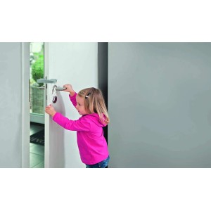 Gyermek nyitja az ajtót Abus JC5200A Millie ajtóütközővel/csillapítóval, mint gyermekbiztonsági eszköz.